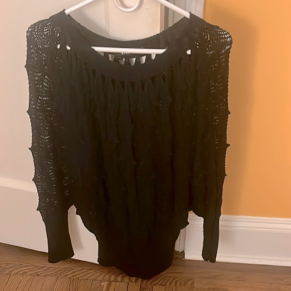 Stylish crochet black sweater with cinched bottom.